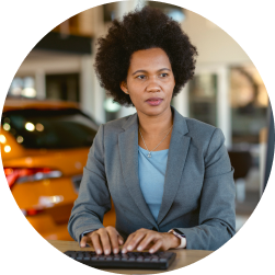 Marketing director of dealership looking at computer in her office