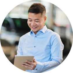 Auto dealership sales manager showing customer data on a tablet